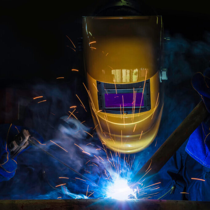 A craftman is welding with workpiece steel